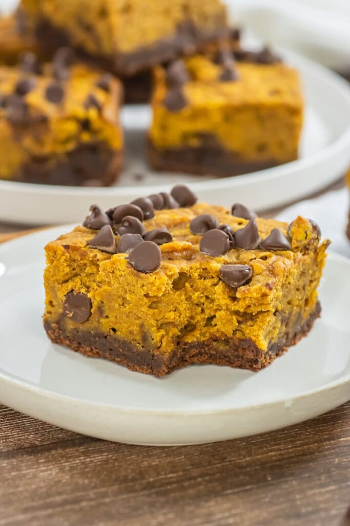 pumpkin brownies resting on a white plate